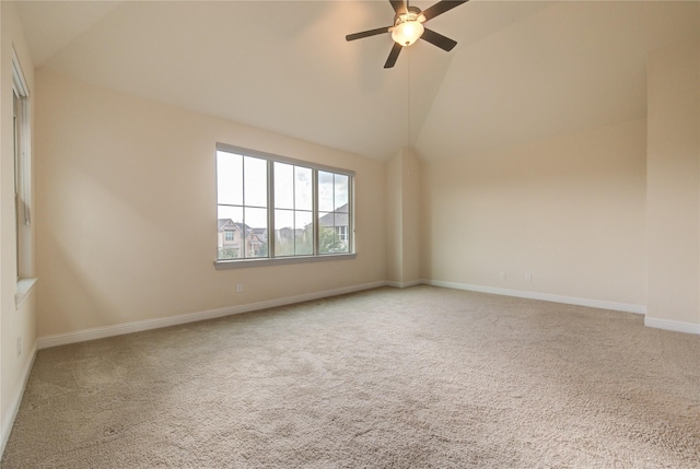 spare room with carpet floors, vaulted ceiling, and ceiling fan