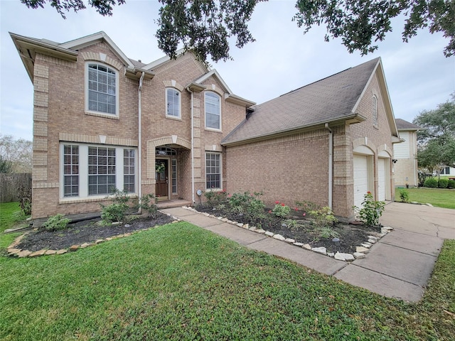 view of front of property featuring a garage and a front lawn