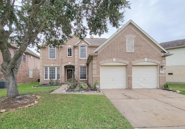 front of property with central AC unit, a front yard, and a garage