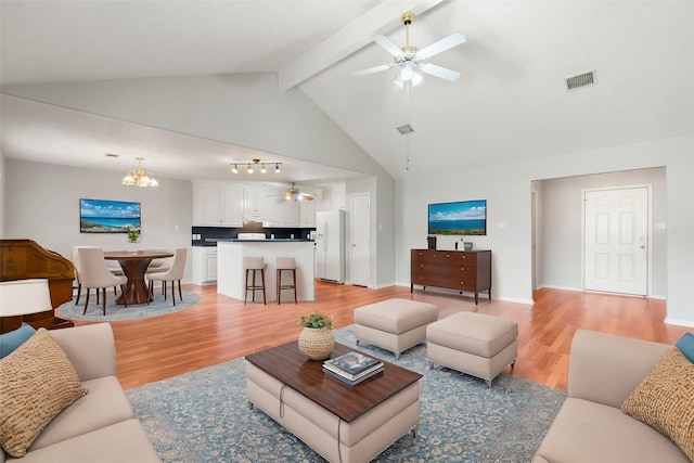 living room with beam ceiling, ceiling fan with notable chandelier, light hardwood / wood-style flooring, and high vaulted ceiling