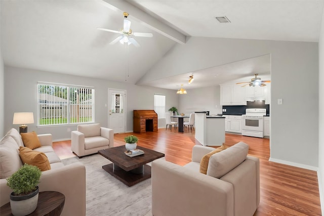 living room with vaulted ceiling with beams, ceiling fan, and light hardwood / wood-style flooring