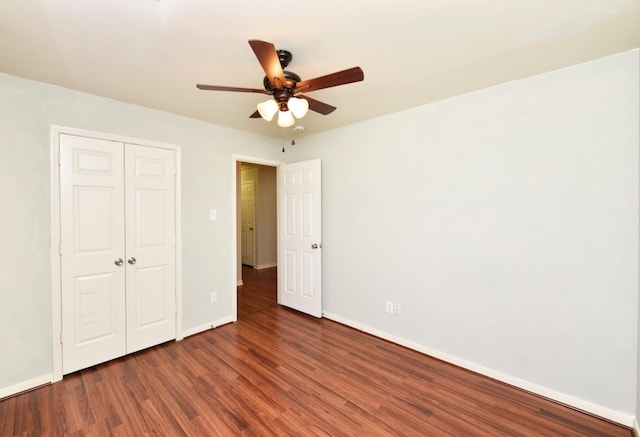 unfurnished bedroom with a closet, ceiling fan, and dark wood-type flooring