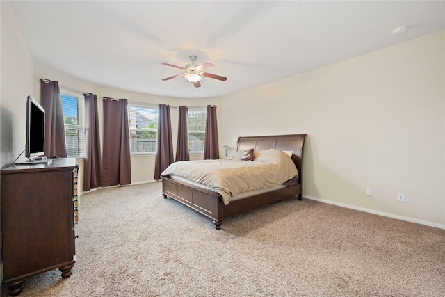 bedroom featuring light colored carpet and ceiling fan