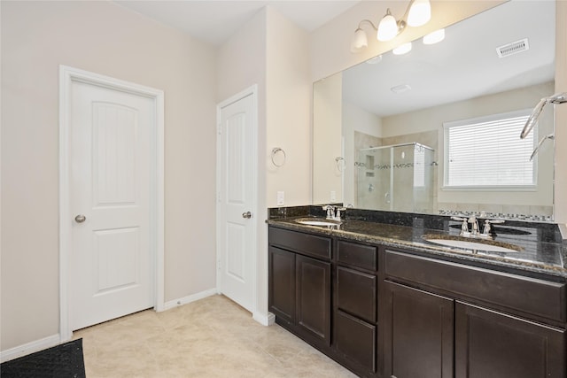 bathroom featuring vanity, tile patterned floors, and a shower with shower door