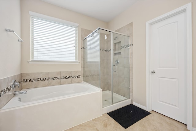 bathroom featuring tile patterned flooring and independent shower and bath