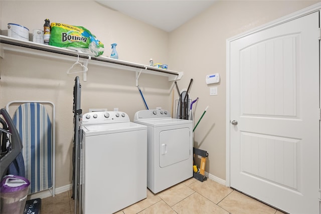 washroom with separate washer and dryer and light tile patterned flooring