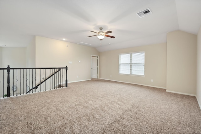 empty room with carpet floors, ceiling fan, and lofted ceiling