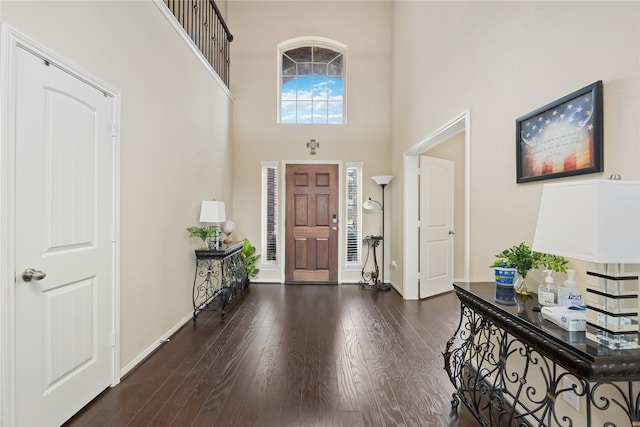 entrance foyer featuring dark hardwood / wood-style flooring and a high ceiling