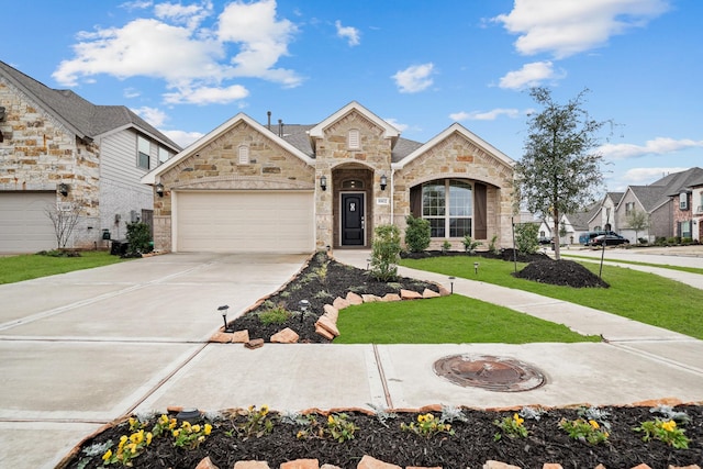 view of front of property featuring a garage and a front yard