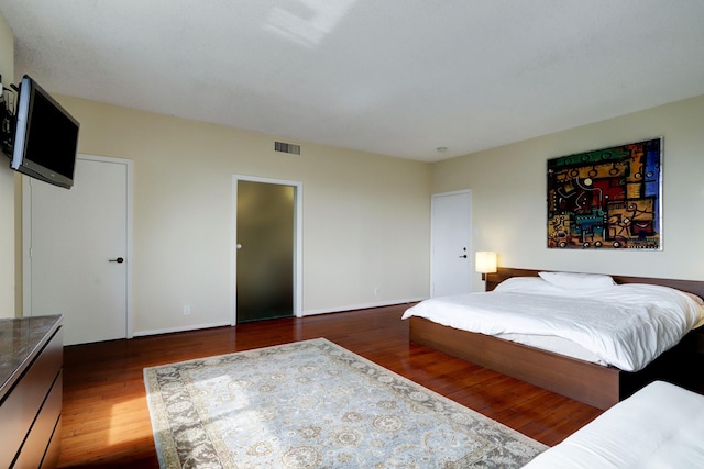 bedroom with dark wood-type flooring