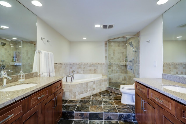 full bathroom featuring vanity, toilet, and independent shower and bath