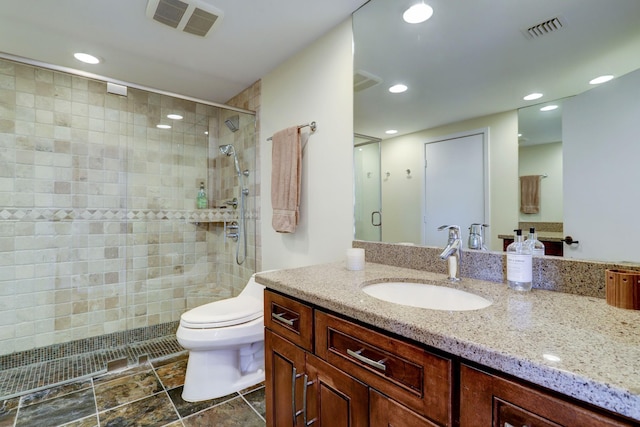 bathroom with walk in shower, vanity, and toilet