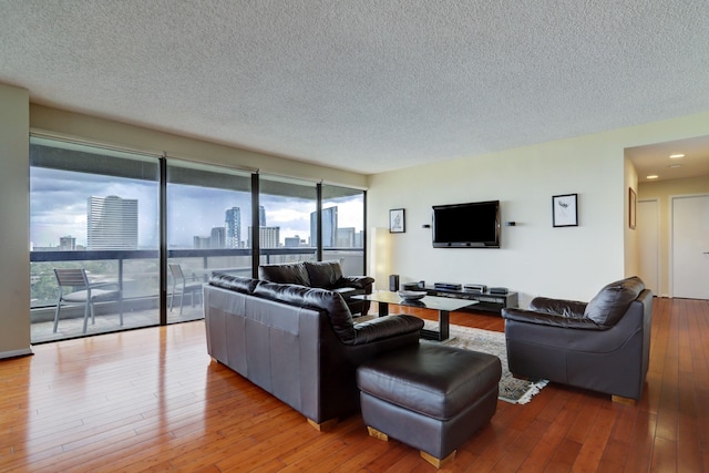 living room featuring a textured ceiling and light hardwood / wood-style flooring