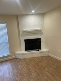 unfurnished living room featuring hardwood / wood-style floors and a fireplace