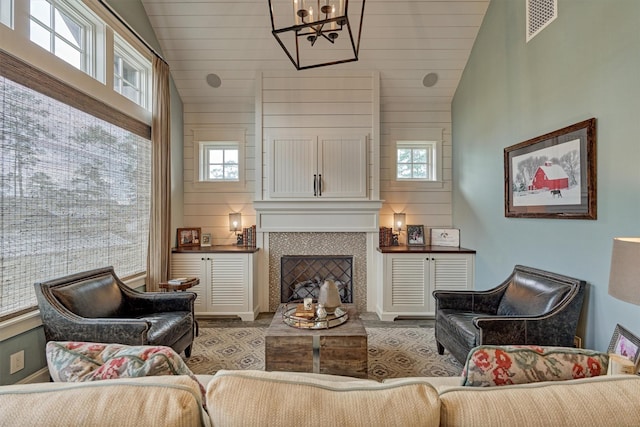 26210 Bluejack National Blvd Unit 14, Montgomery, TX 77316 - living room with a tiled fireplace, a wealth of natural light, and a notable chandelier