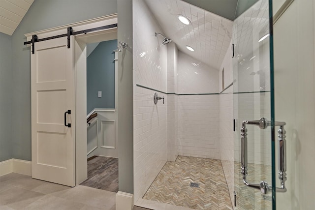 26210 Bluejack National Blvd Unit 14, Montgomery, TX 77316 - bathroom with tile patterned floors, vaulted ceiling, and walk in shower