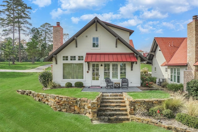 back of property with a yard and a patio