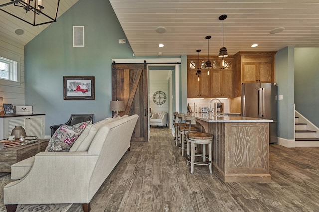 26210 Bluejack National Blvd Unit 14, Montgomery, TX 77316 - kitchen with high end refrigerator, dark hardwood / wood-style flooring, a barn door, decorative light fixtures, and wooden ceiling