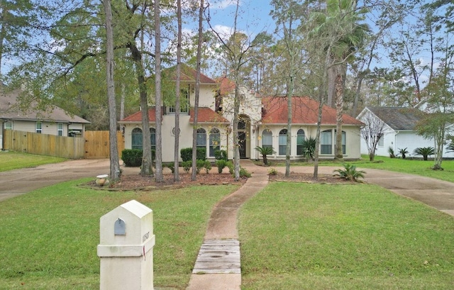 mediterranean / spanish house featuring a front yard