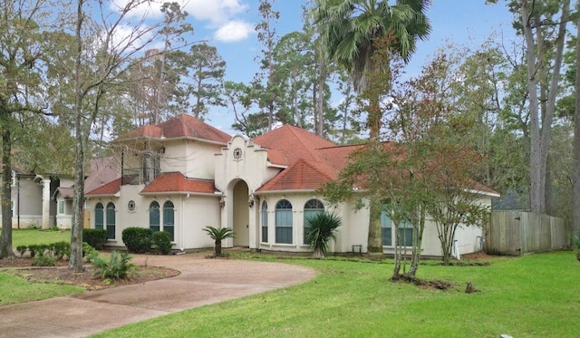 mediterranean / spanish-style house featuring a front lawn