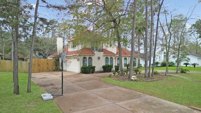 mediterranean / spanish home featuring a front lawn and a garage