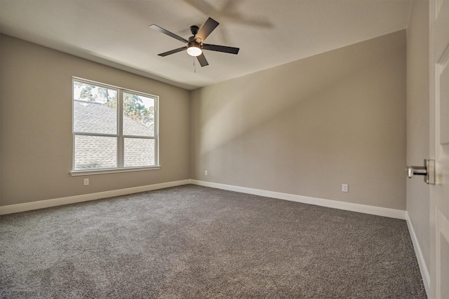 empty room with ceiling fan and dark carpet