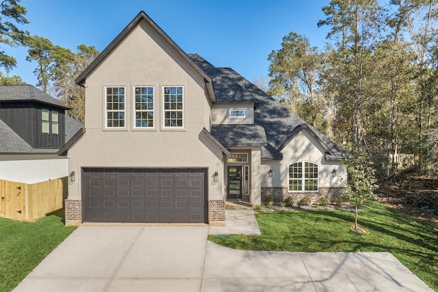 view of front of property with a front lawn and a garage