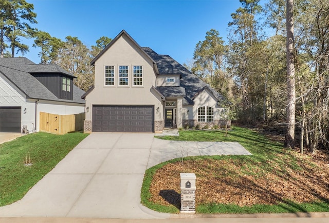 3050 Willowbend Rd, Montgomery, TX 77356 - view of front of property with an attached garage, driveway, a front yard, stucco siding, and brick siding