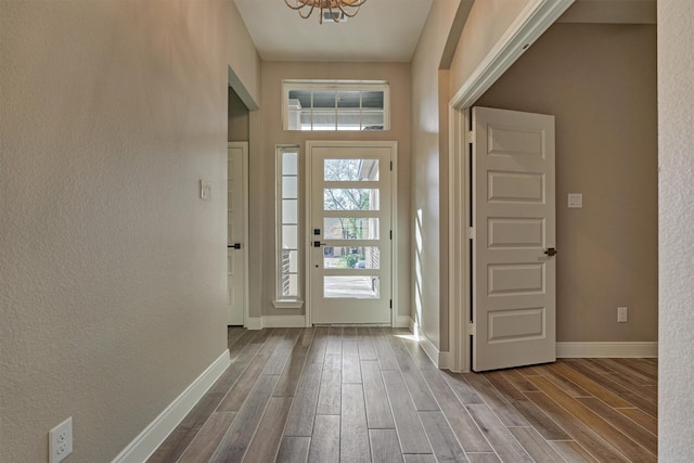 entryway with a notable chandelier and hardwood / wood-style flooring