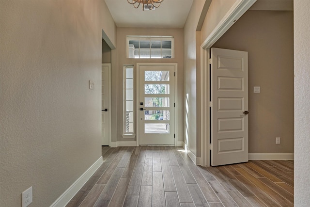 3050 Willowbend Rd, Montgomery, TX 77356 - entrance foyer with wood finished floors, a chandelier, and a textured wall