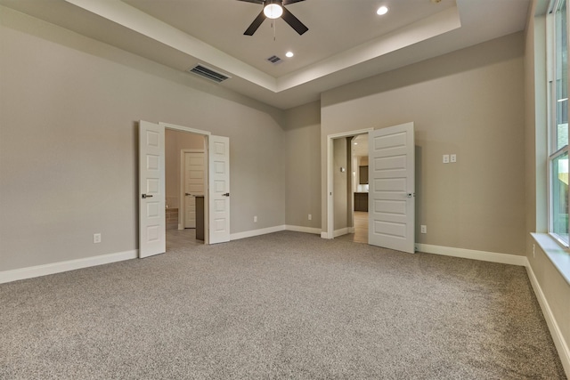 3050 Willowbend Rd, Montgomery, TX 77356 - unfurnished bedroom featuring a tray ceiling, recessed lighting, and carpet