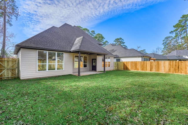 back of house featuring a patio area and a lawn