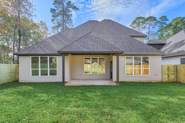 rear view of property with a lawn, a patio area, and ceiling fan