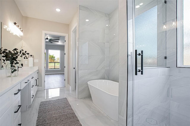 bathroom featuring vanity, ceiling fan, and independent shower and bath