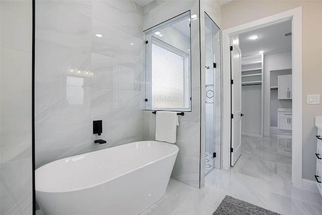 bathroom featuring vanity and a tub to relax in