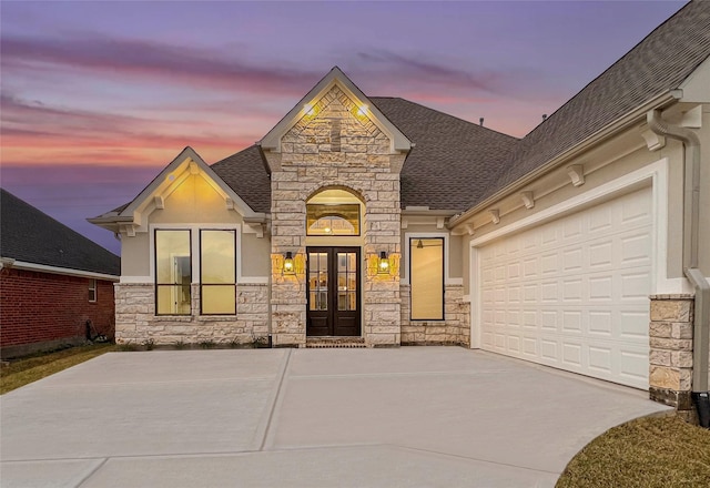 view of front of home with french doors and a garage