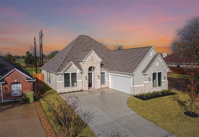 view of front of house featuring a lawn and a garage