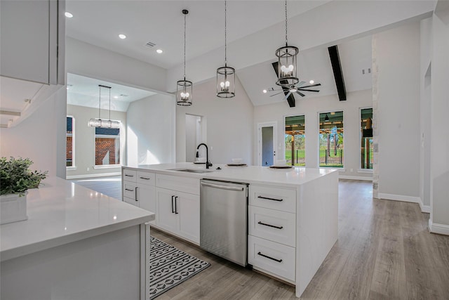 kitchen featuring hanging light fixtures, a center island with sink, stainless steel dishwasher, and ceiling fan