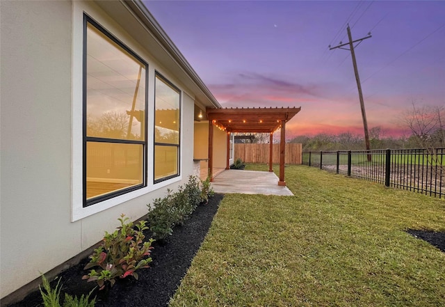 yard at dusk with a pergola and a patio area