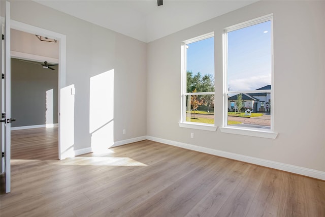 empty room featuring ceiling fan and light hardwood / wood-style floors