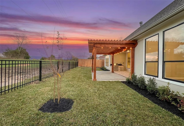 yard at dusk with a pergola and a patio