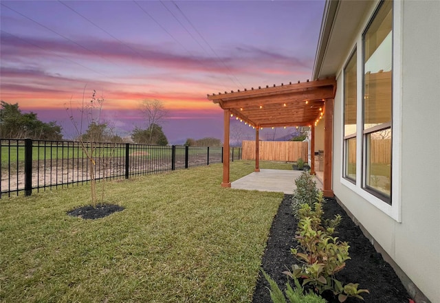 yard at dusk featuring a pergola and a patio area