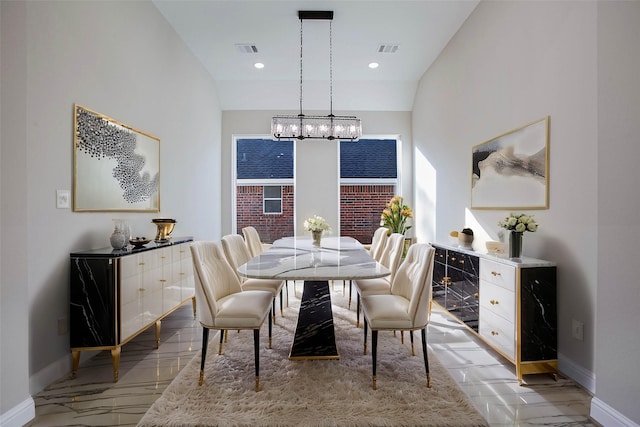 dining area with a chandelier and lofted ceiling