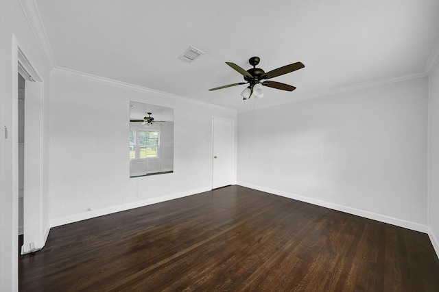 empty room featuring ornamental molding and dark wood-type flooring