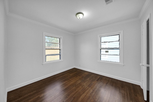 spare room featuring dark hardwood / wood-style flooring and ornamental molding