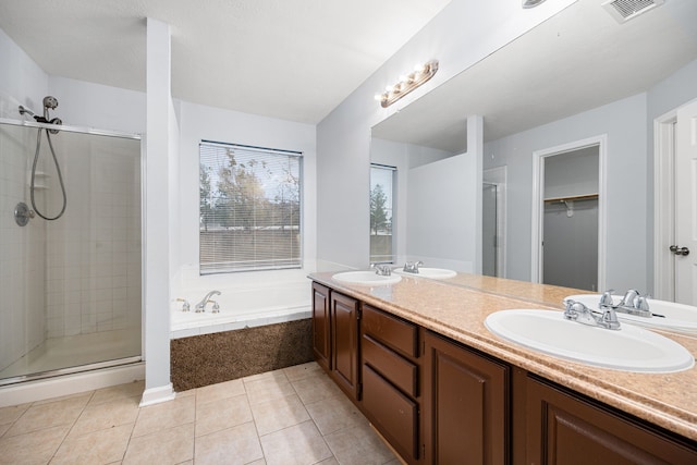 bathroom with plus walk in shower, vanity, and tile patterned floors