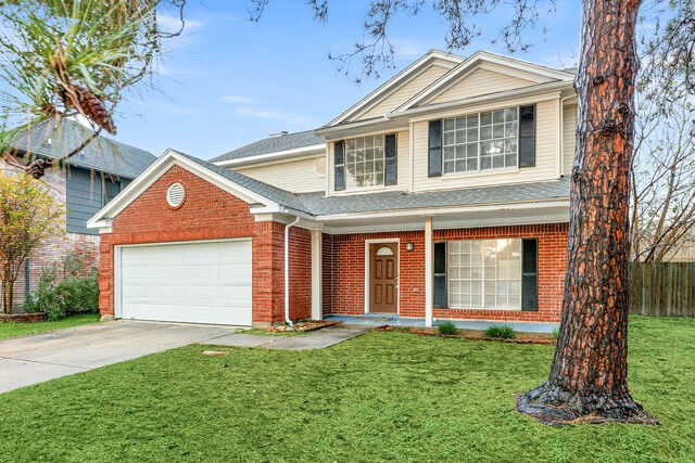 view of front property with a garage and a front yard