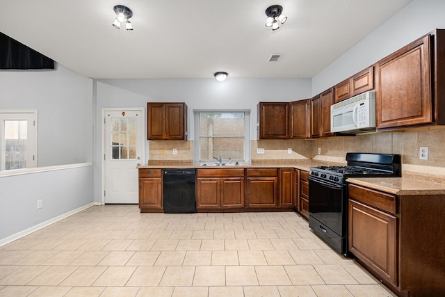 kitchen with black appliances, sink, decorative backsplash, light tile patterned floors, and light stone counters