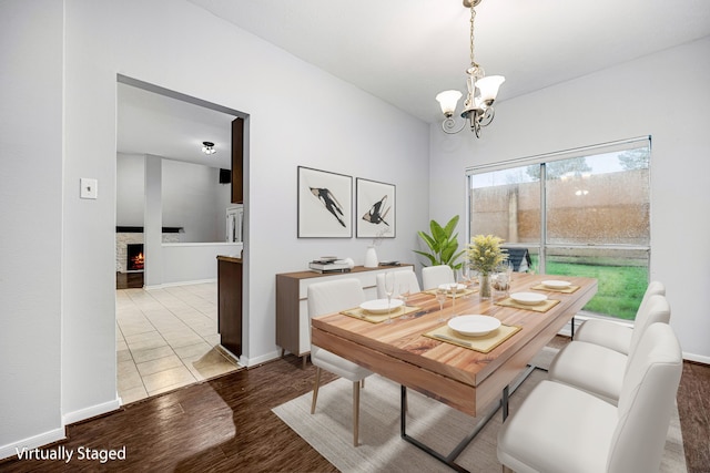 dining space with wood-type flooring and a notable chandelier