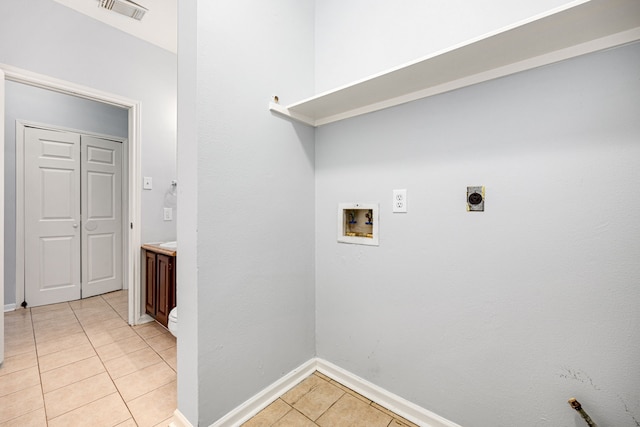 laundry room featuring electric dryer hookup, light tile patterned floors, and washer hookup